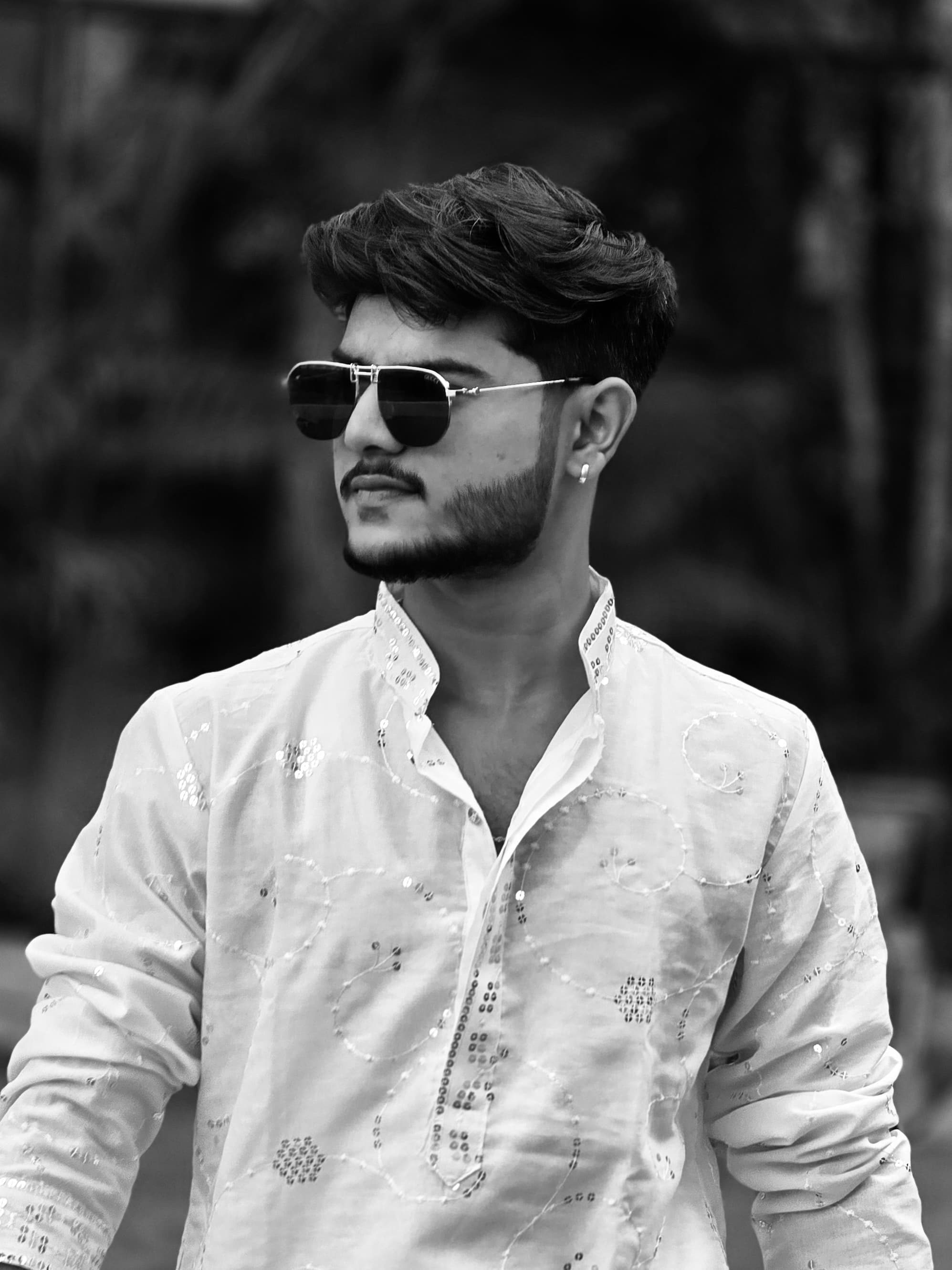 Saksham Solanki, founder of Velmont Clothing, in a white embroidered kurta and sunglasses